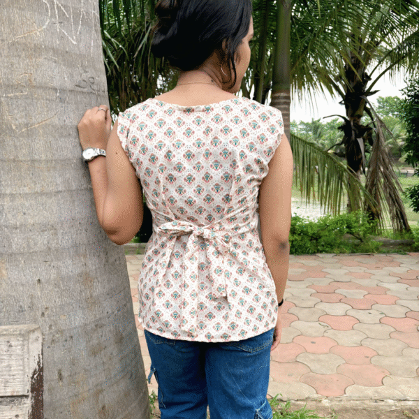 rayon printed sleeveless kurti with front slit – soft peach & multicolor motif